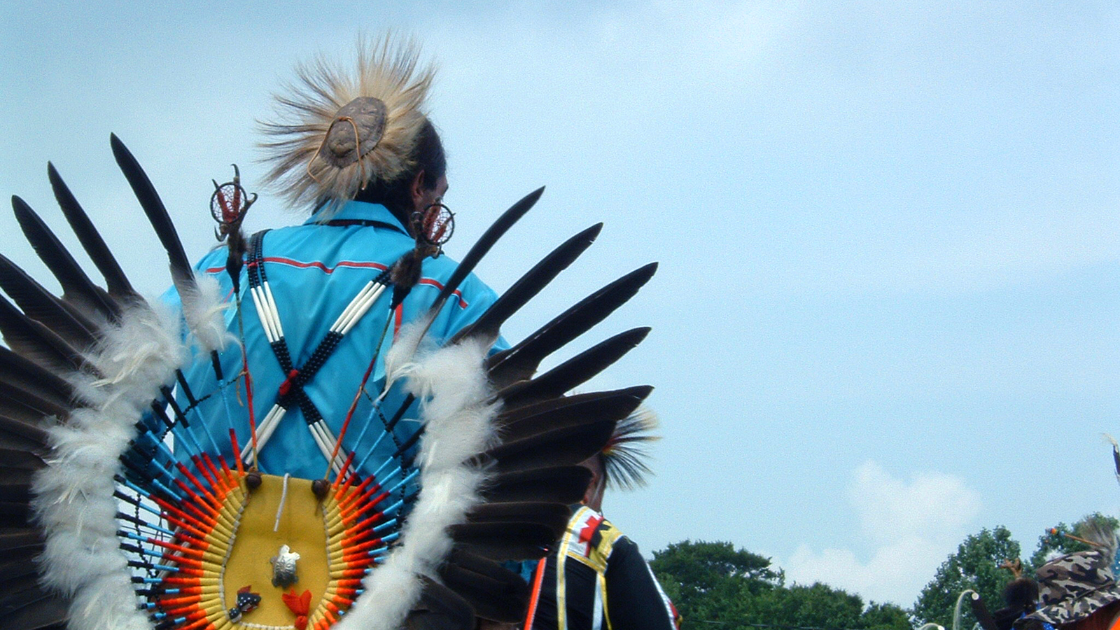 An indigenous man participates in a pow wow